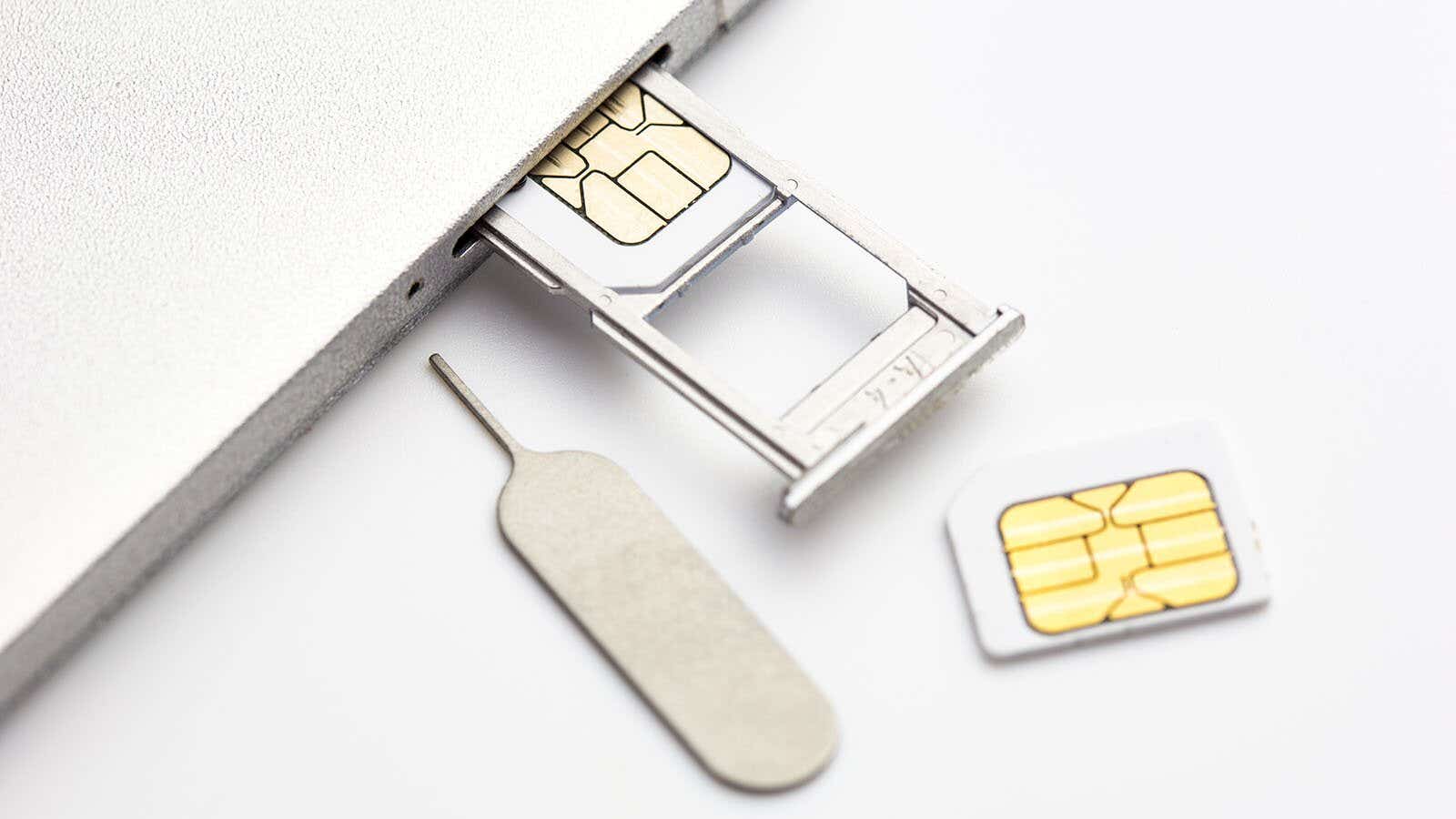 sim card next to a sim tray in a mobile phone