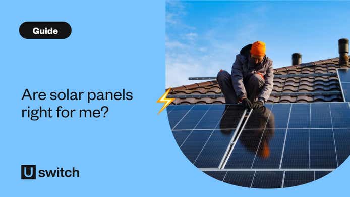 Engineer installing solar panels on roof of house