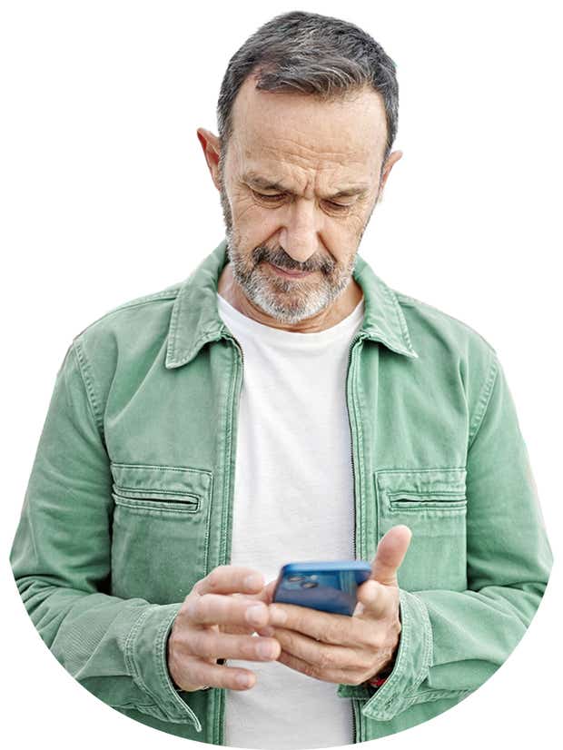 Middle aged male looking down at phone in his hand