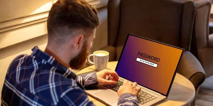 man changing password on laptop