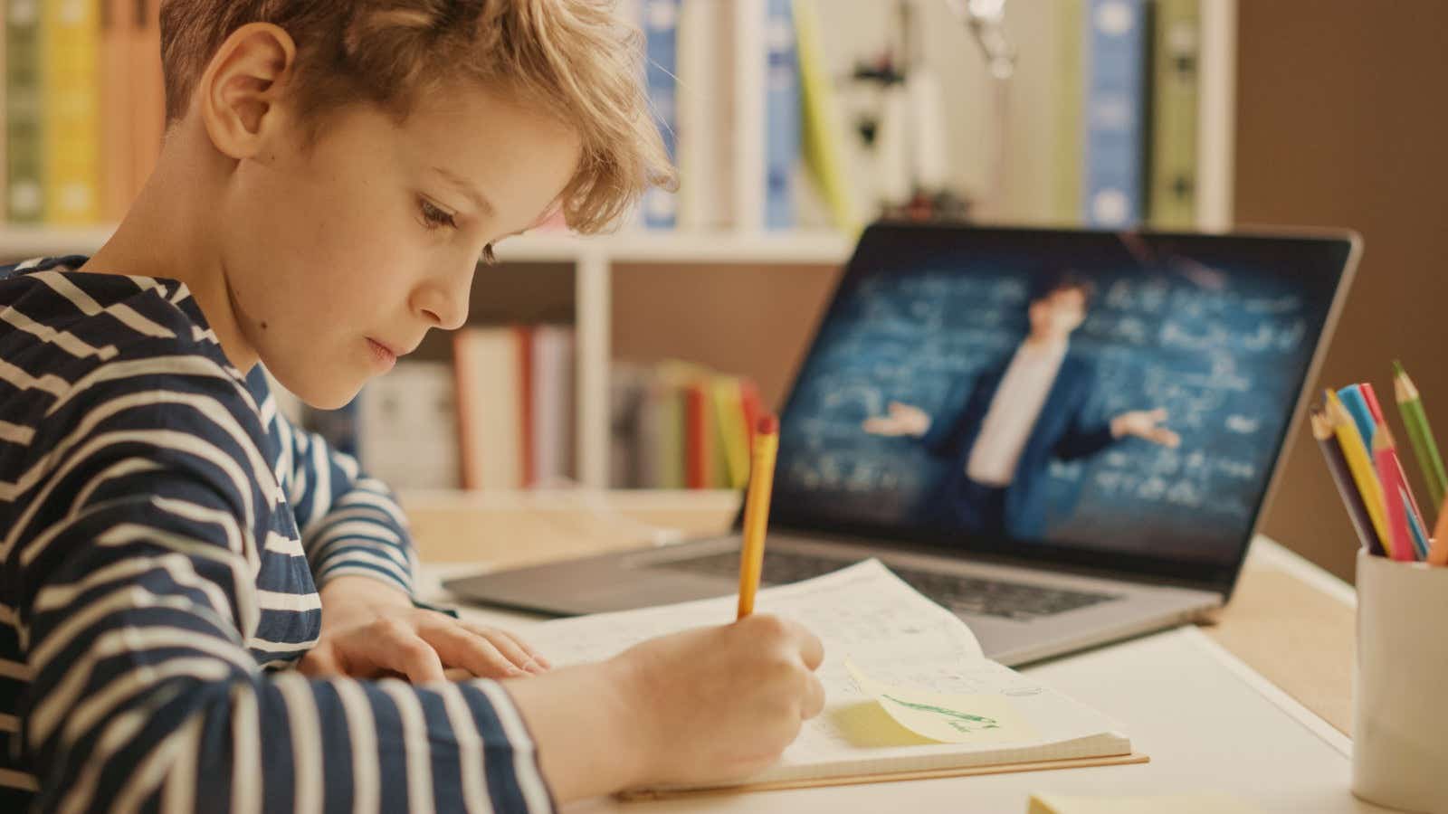 child learning from home with his teacher on a video call