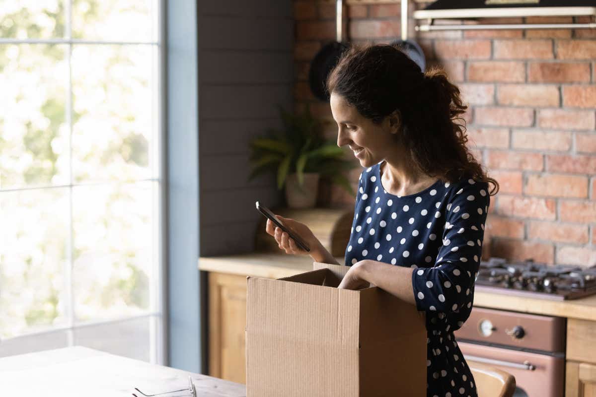 Woman packing up kitchen as she moves home