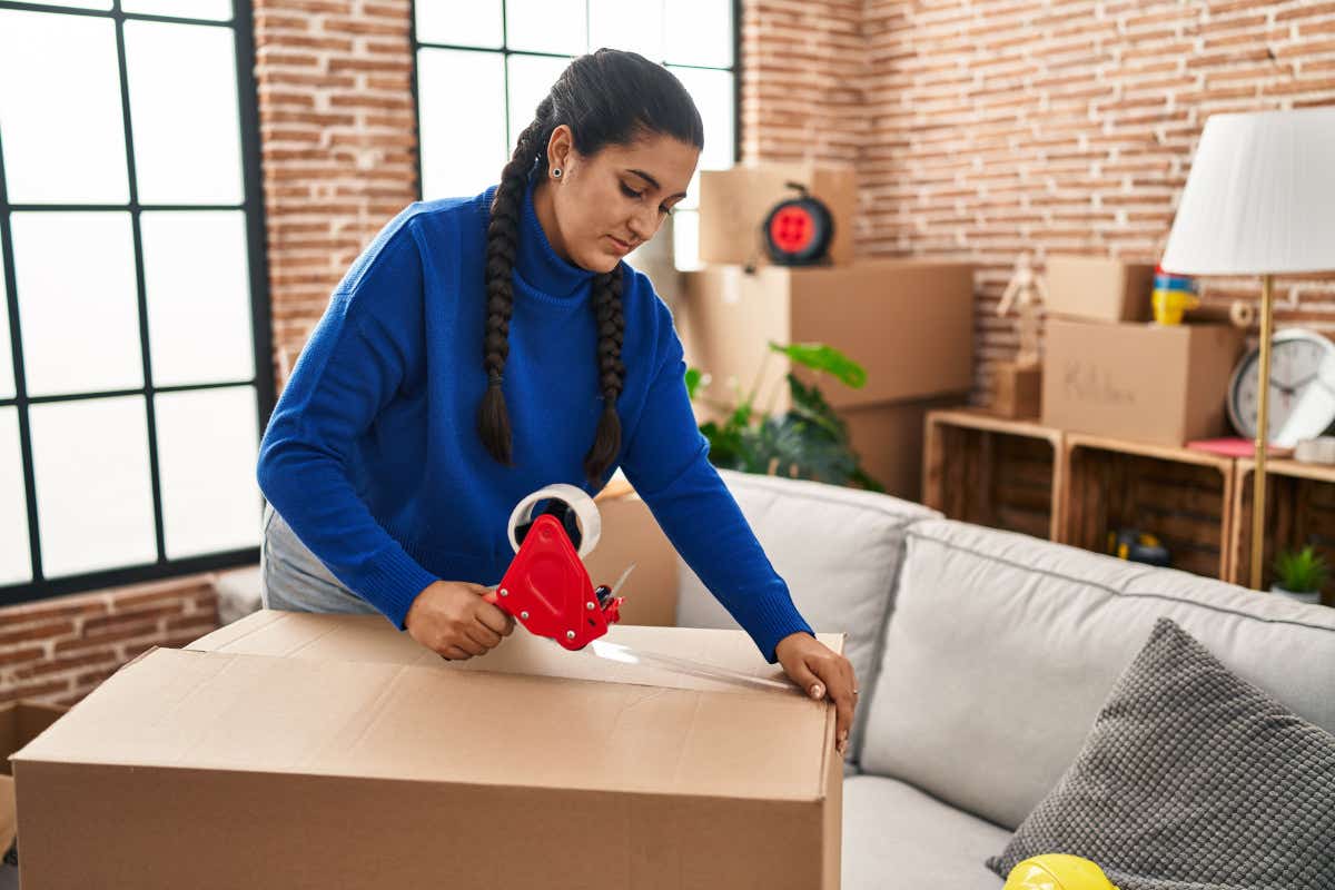 Woman packing boxes as she moves house