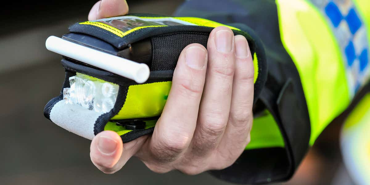 Breathalyser in policeman's hand