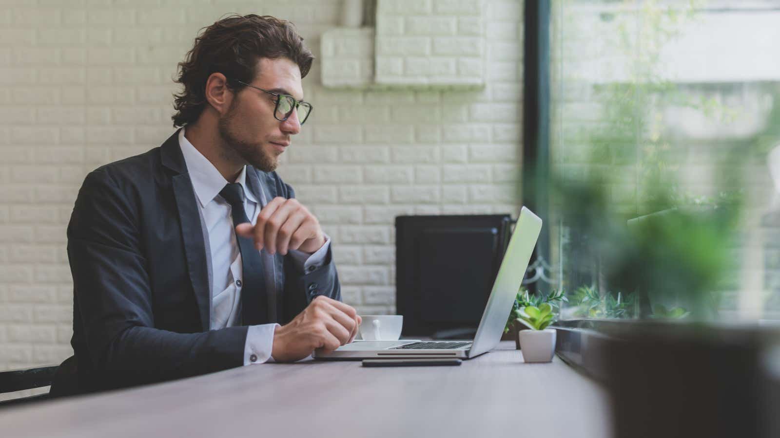 professional man using laptop broadband cafe