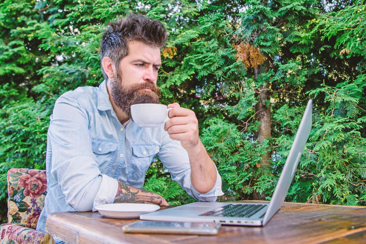 Man in garden drinking coffee