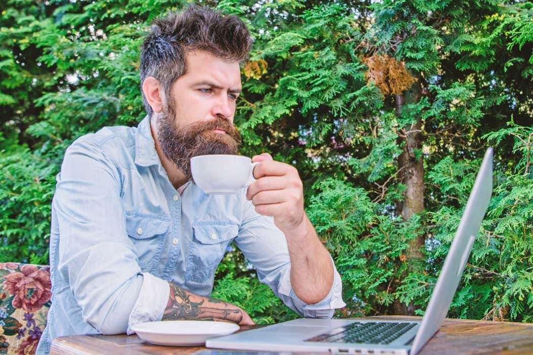 Man in garden drinking coffee