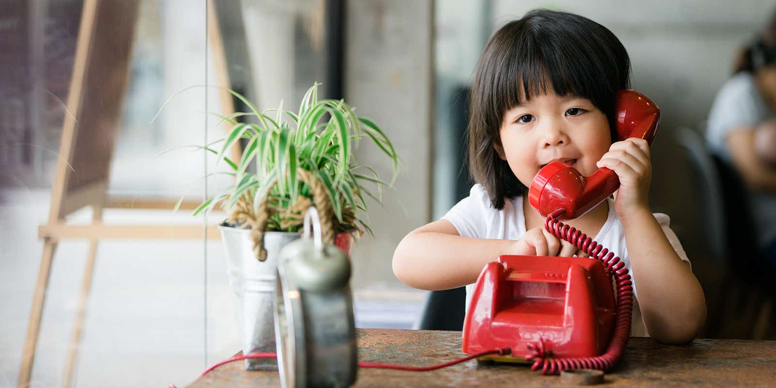 girl using an old rotary landline phone