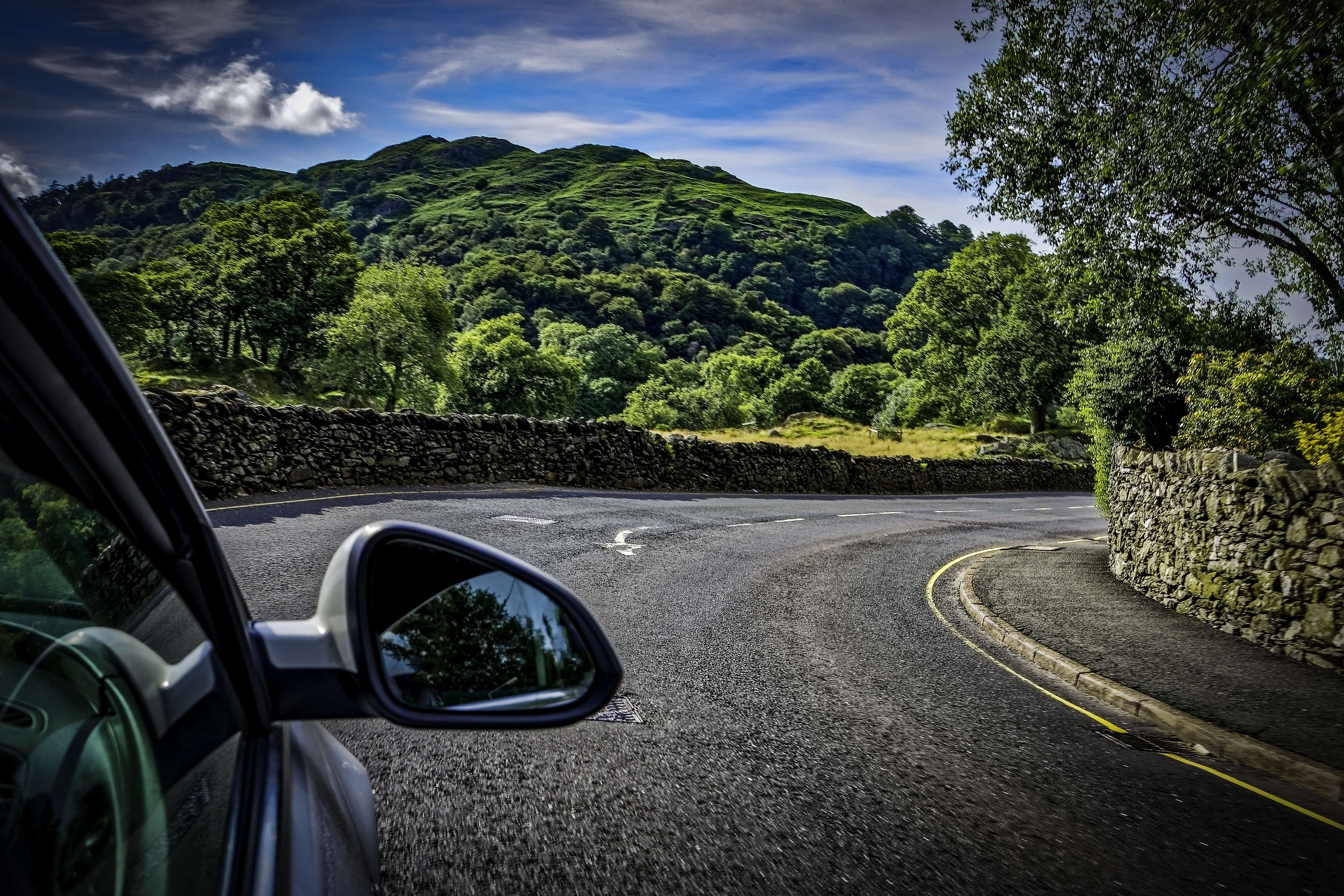 A car driving through a country road in the lake district in England, UK