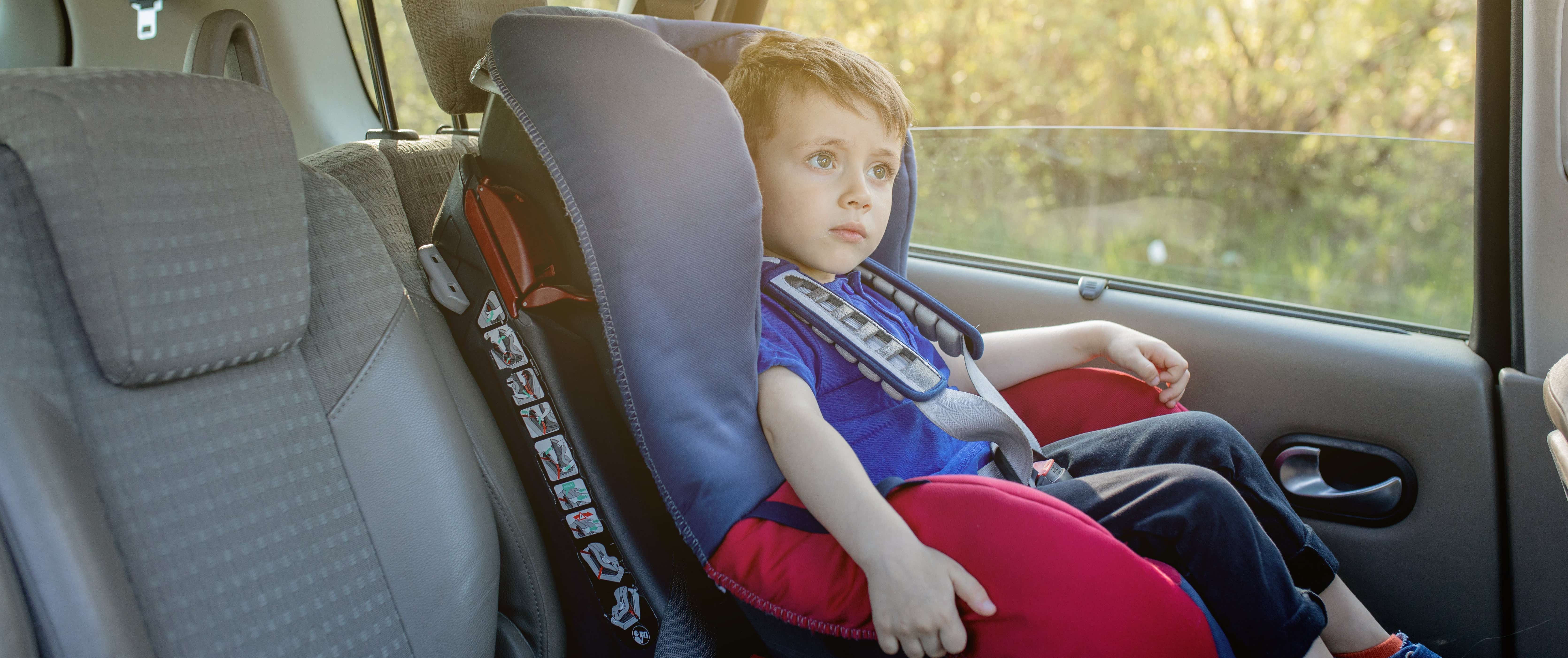 Child in car seat in back of car 