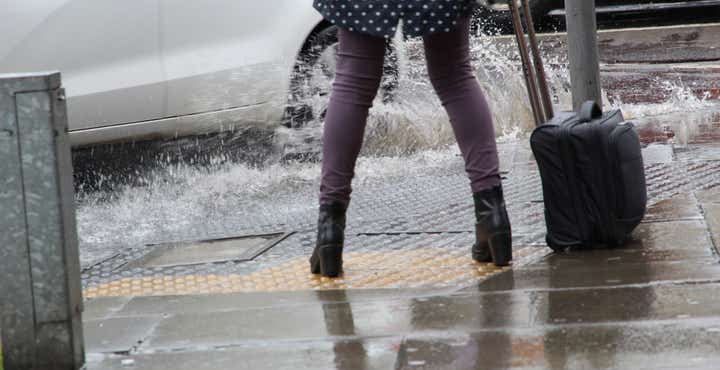 Pedestrian getting splashed by a puddle 