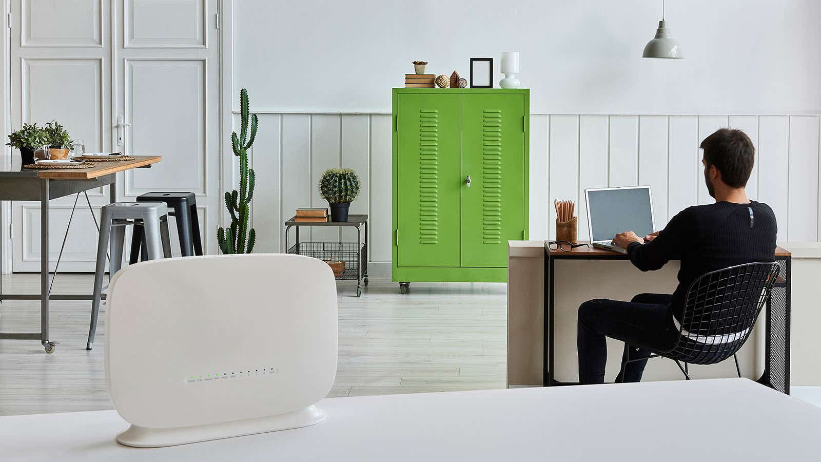 man with broadband router