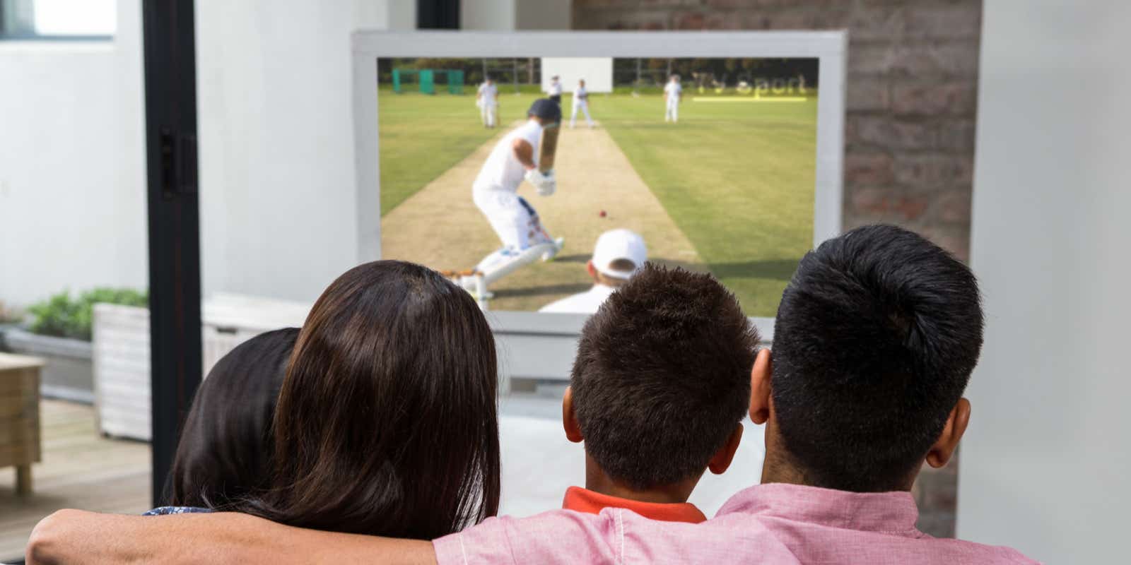 family watching the cricket on TV