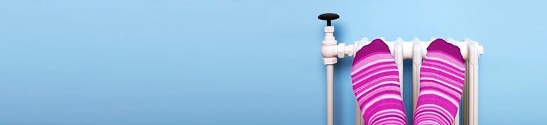 Feet up on radiator for warmth