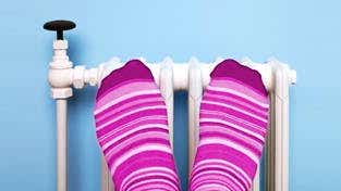 Feet up on radiator for warmth