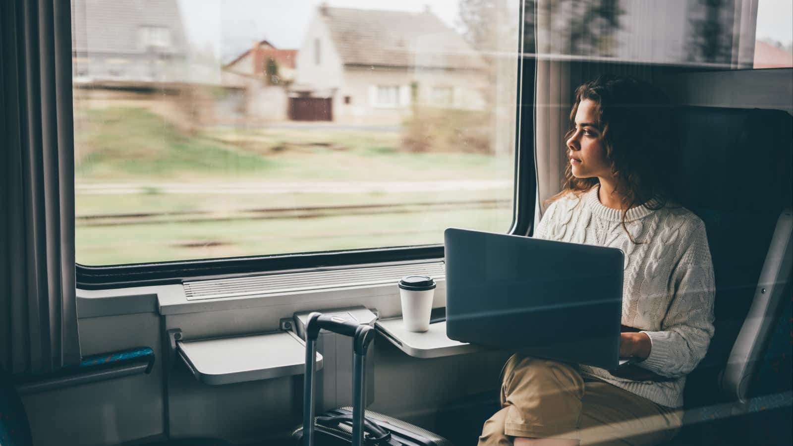 woman working with laptop on the train