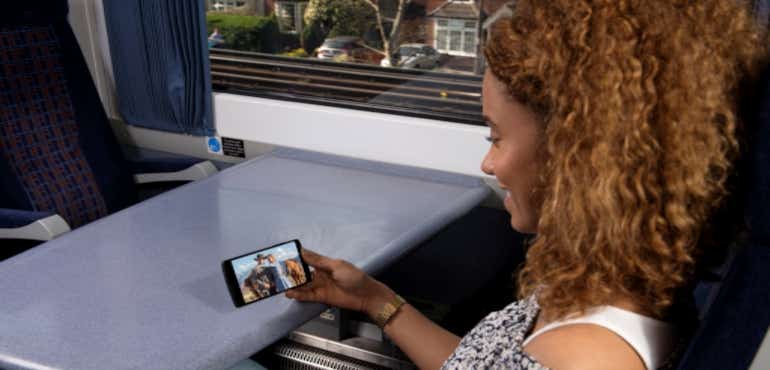 Woman using Sky Mobile on the train