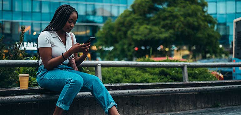 woman using her 5G smartphone in a city