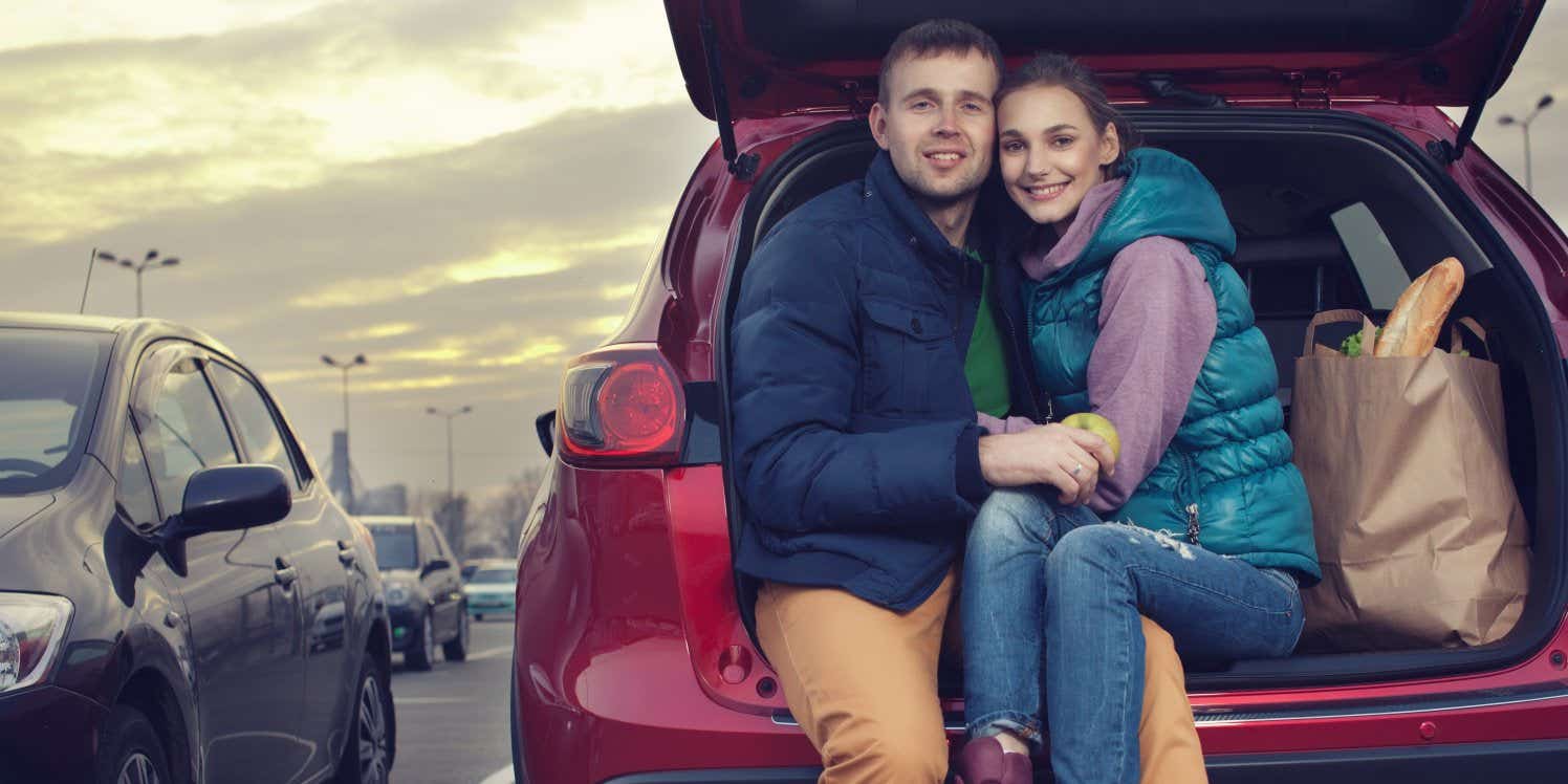 couple-sat-in-boot-of-car