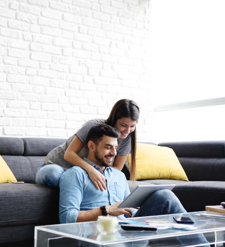 Young couple using a tablet 768 x 845