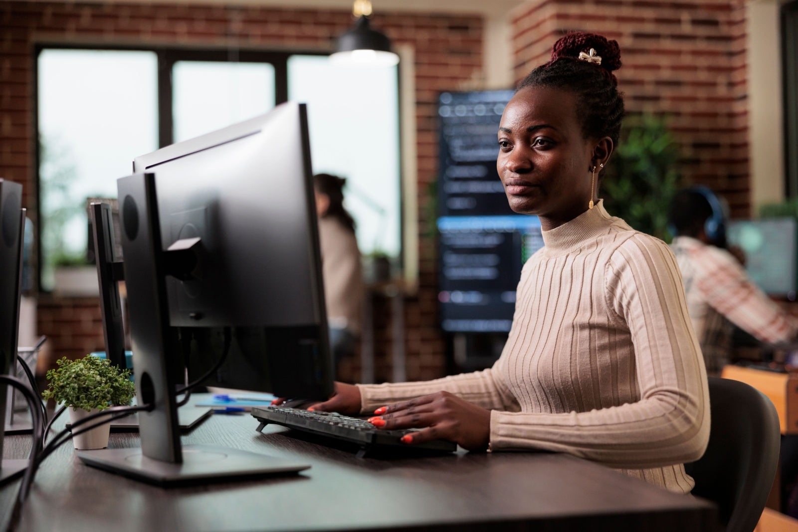Young businesswoman in an office using a desktop computer