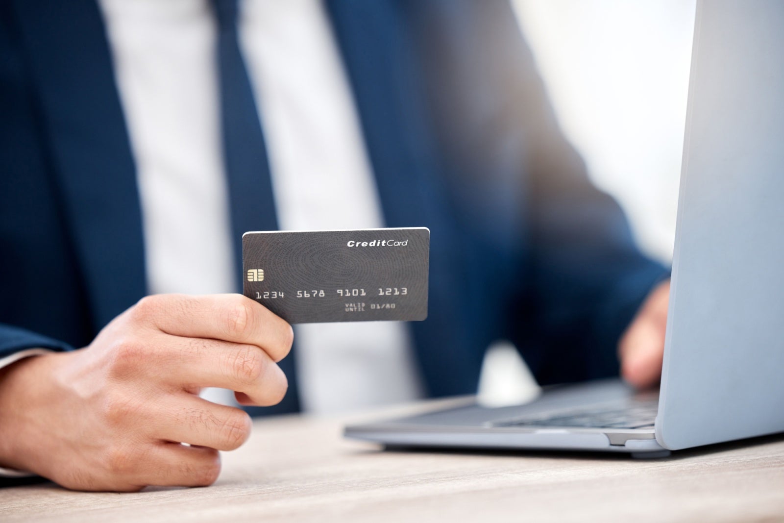 Close up of a credit card in a businessman's hand