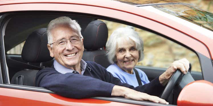 old-couple-driving-car-on-road.CDN5e66117f