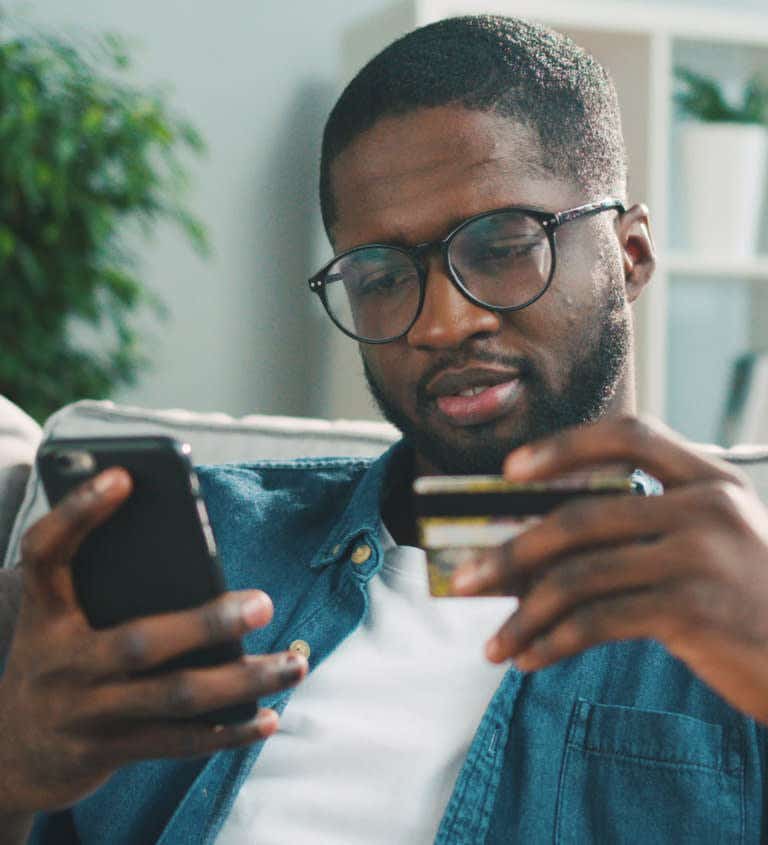 Man using credit card and mobile
