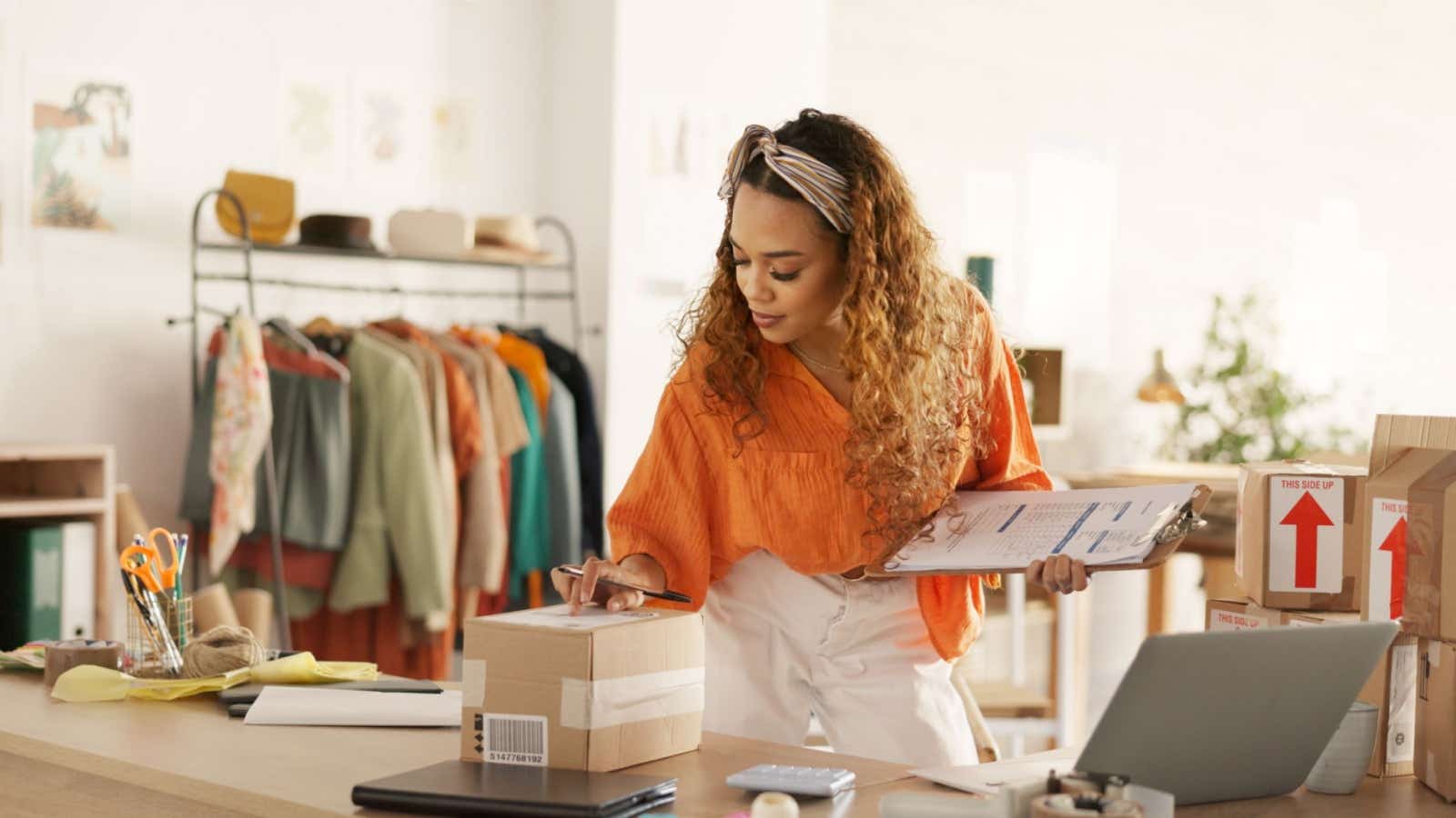 Clothes retailer packaging up items to send to customers