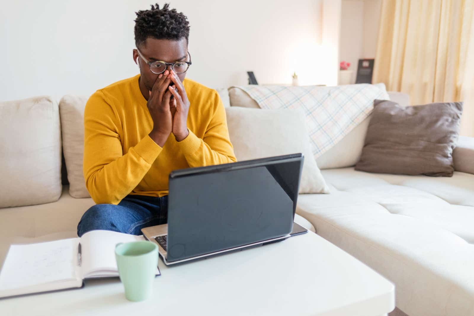 Man shocked at something he has seen on his laptop's screen