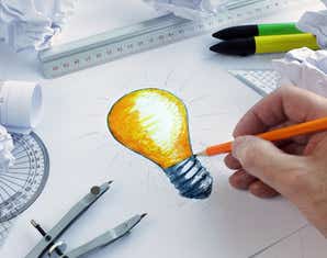 Graphic designer drawing lightbulb