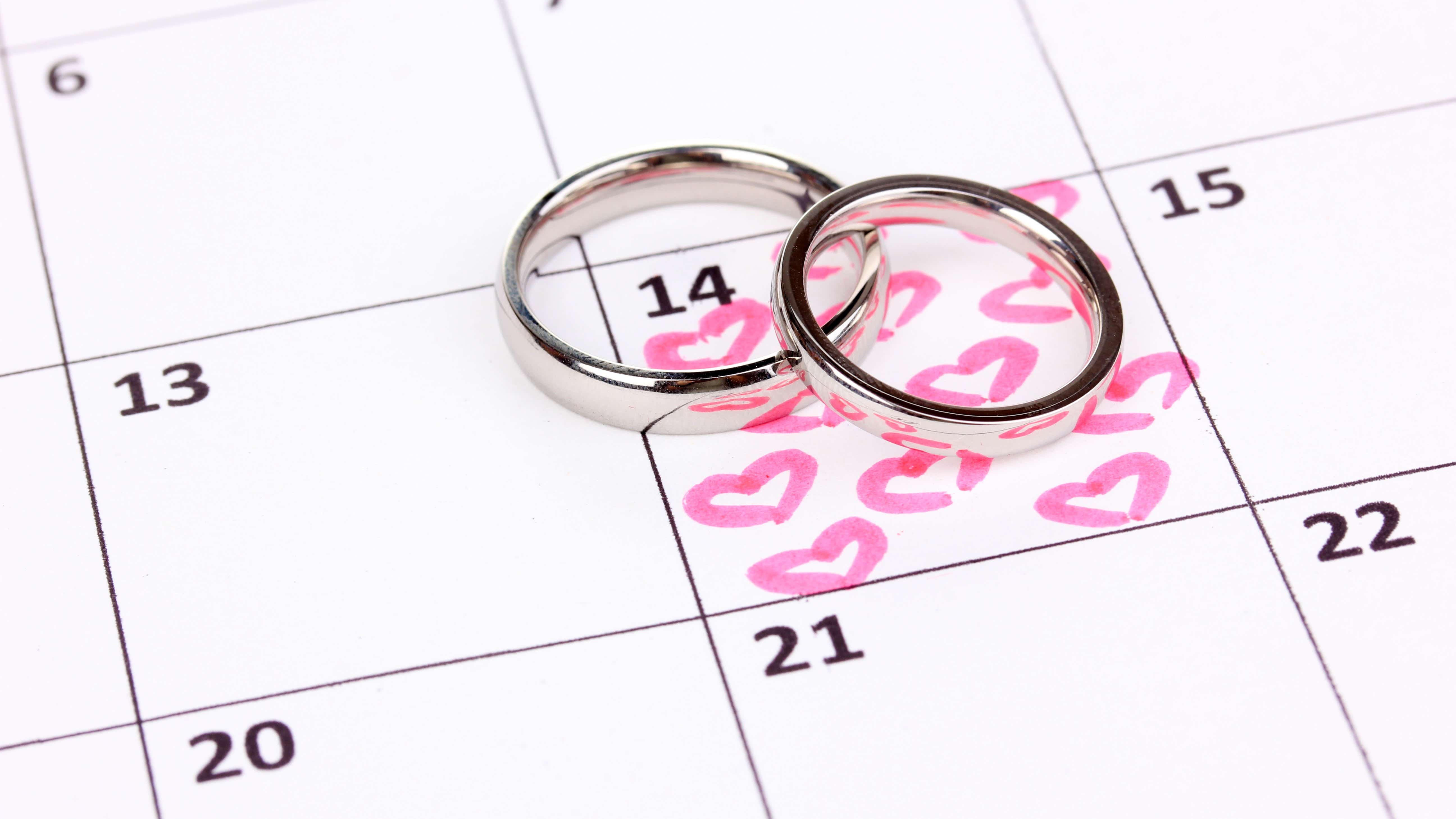 Wedding rings on a calendar marked with the wedding date