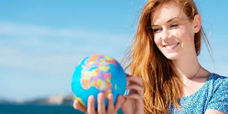 young-woman-outside-holding-globe