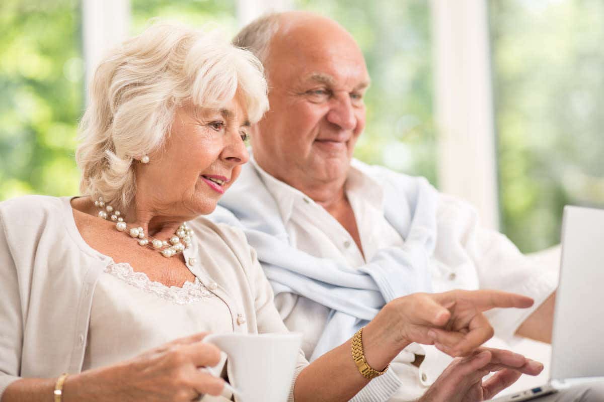 Older couple looking at a laptop screen