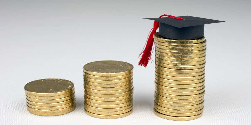 Picture of coins stacked up next to each other with a graduation cap on top of third stack of coins