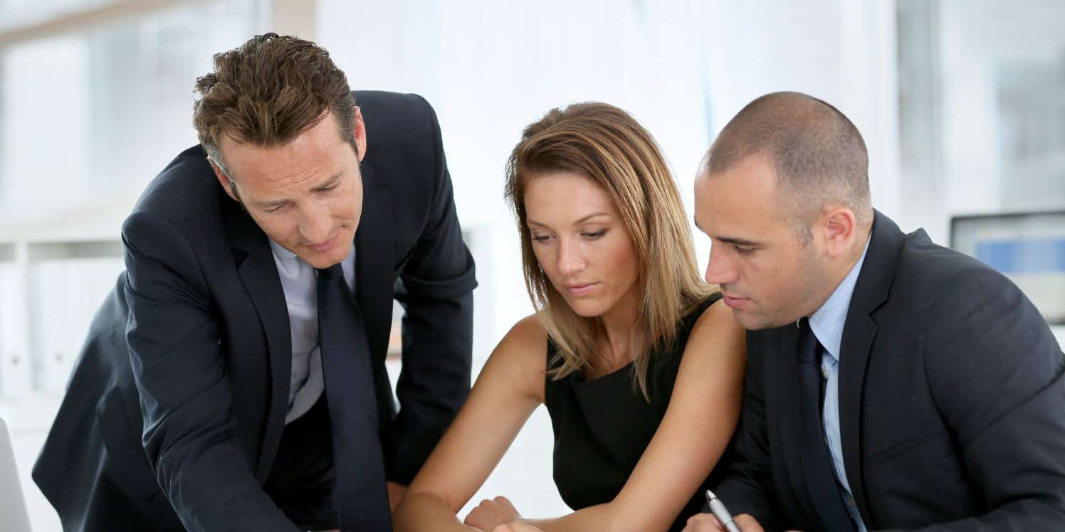 couple discussing paperwork with financial advisor