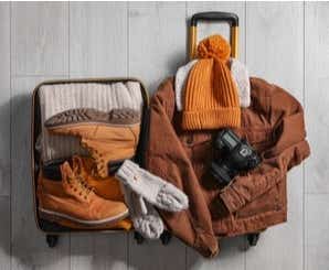 travel insurance uk price Suitcase full of clothes