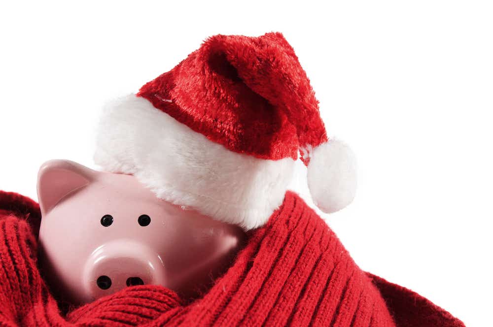 Piggy bank with Santa hat and festive scarf. 
