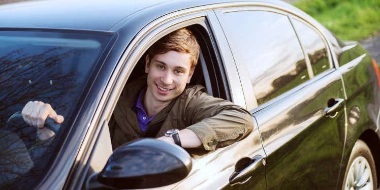 young-man-happy-in-new-car.CDN5e66117f