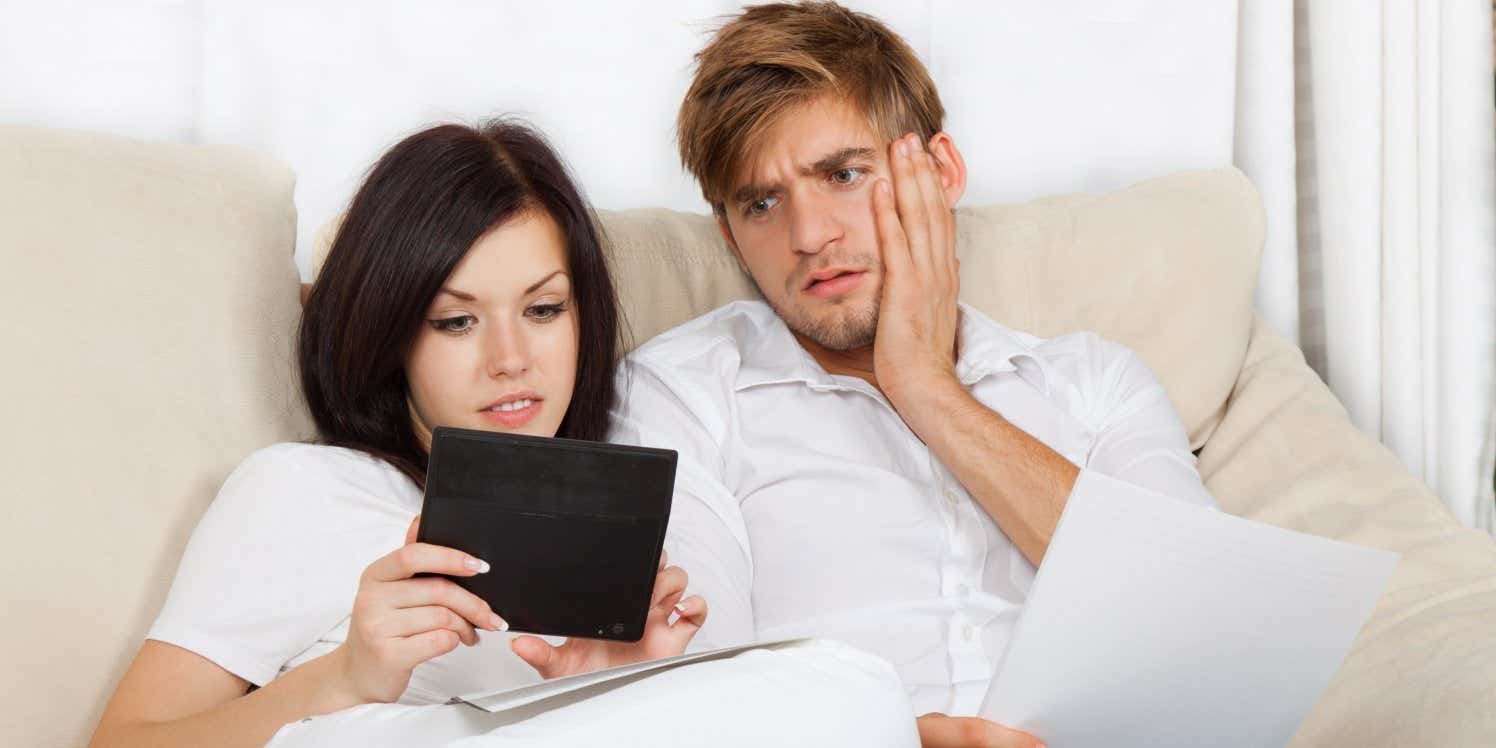 Man and woman on sofa looking at tablet