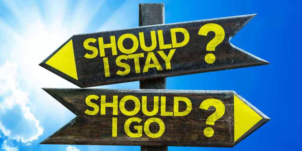 Signs pointing in different directions saying should i stay or should i go