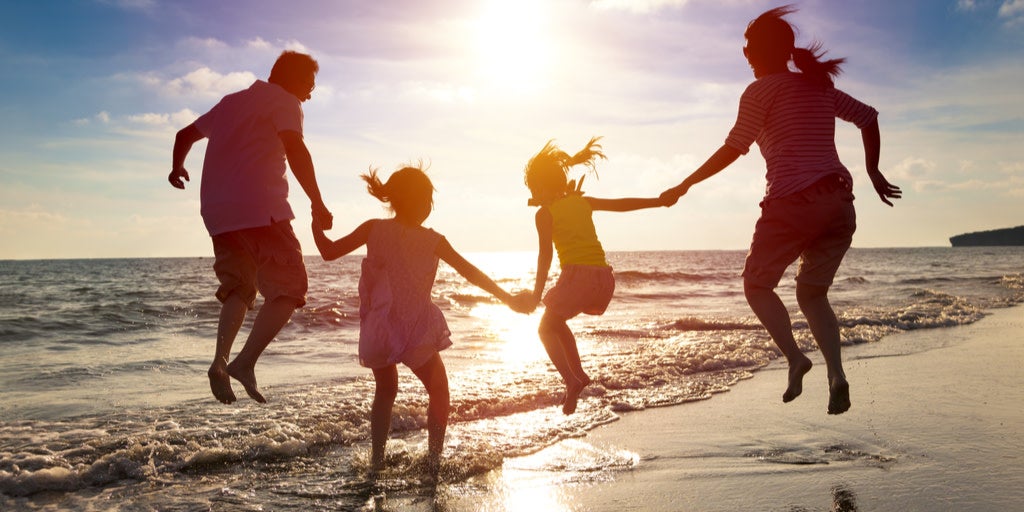 family silhouette at beach