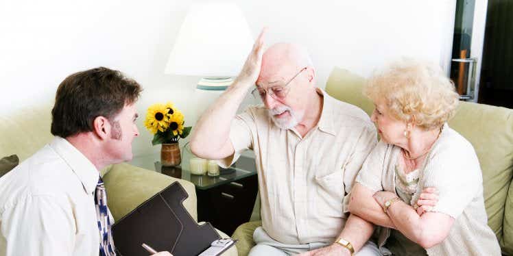 older-man-and-woman-with-advisor-at-home