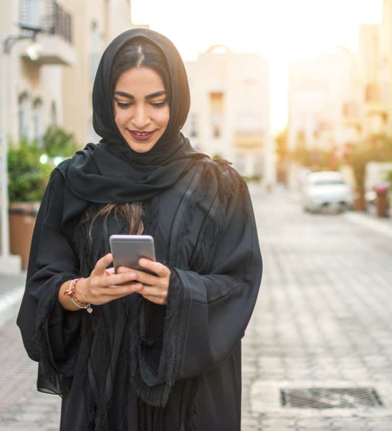Woman wearing hijab using mobile phone