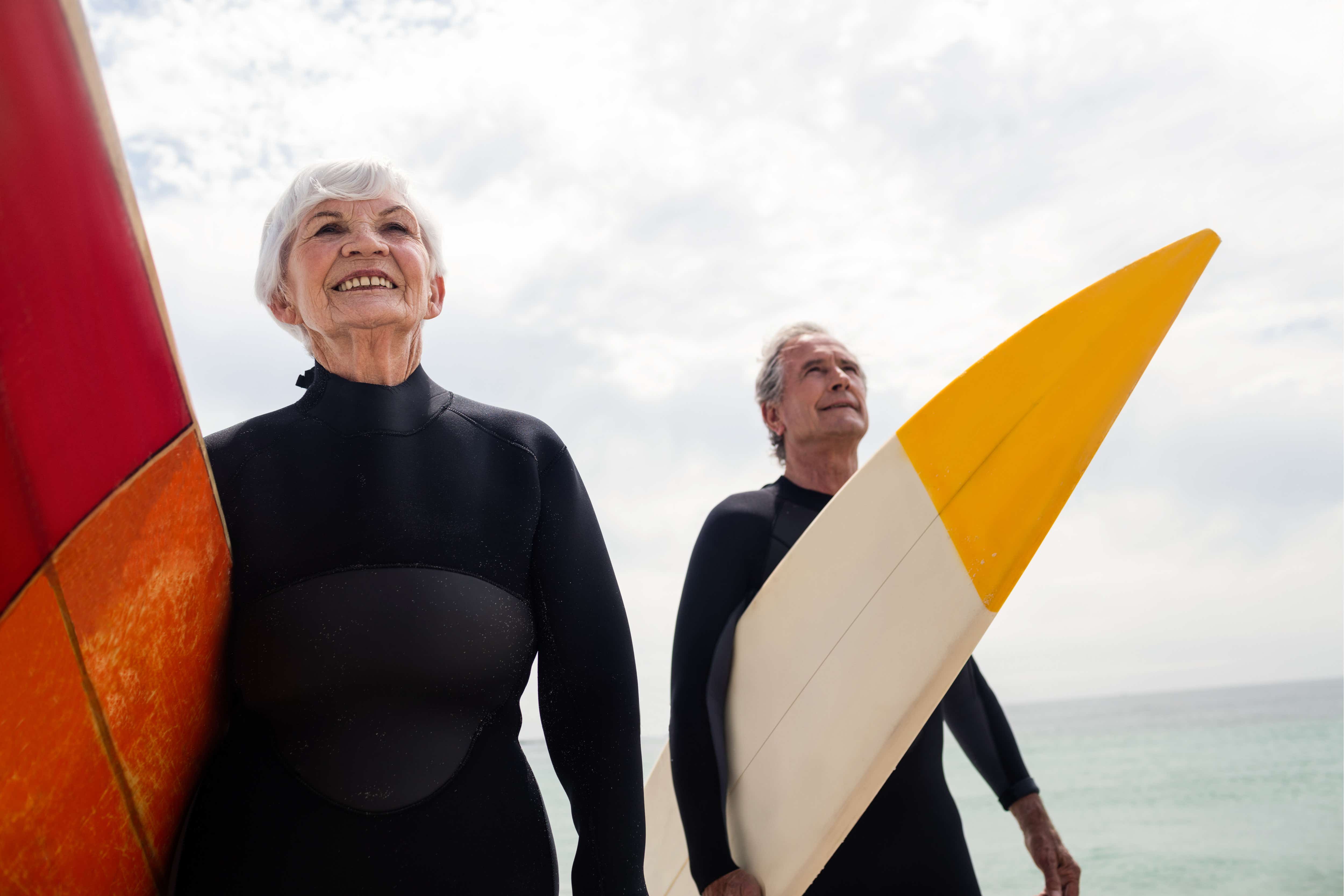Older couple coming in from surfing the waves