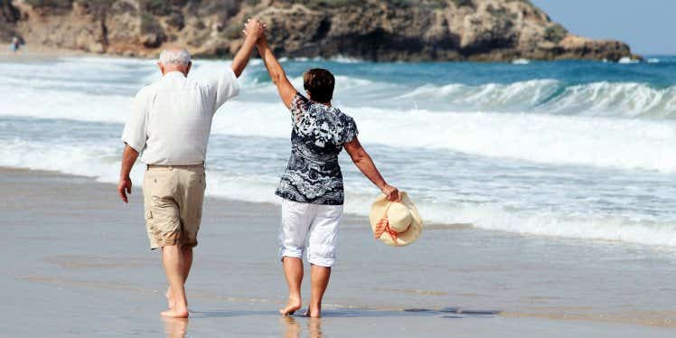senior-couple-walking-on-the-beach
