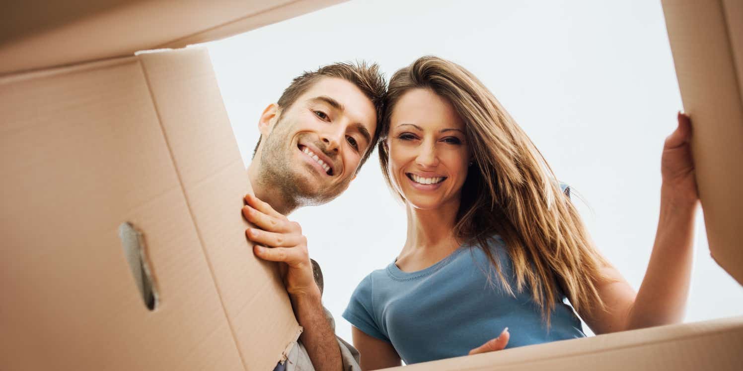 Couple looking into a cardboard packing box