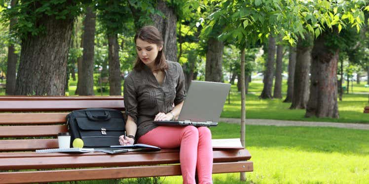 woman-working-on-laptop-in-park