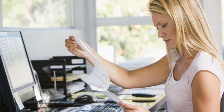 woman-desk-paperwork-confused