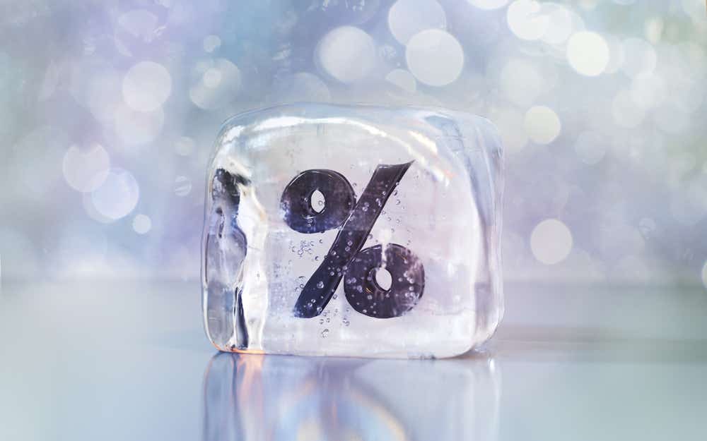 Ice cube with a frozen percentage symbol 